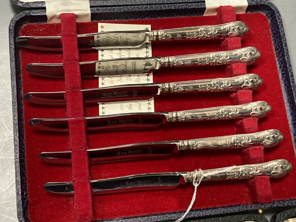A cased set of six 1930s silver teaspoons and a cased set of six silver handled cake knives.
